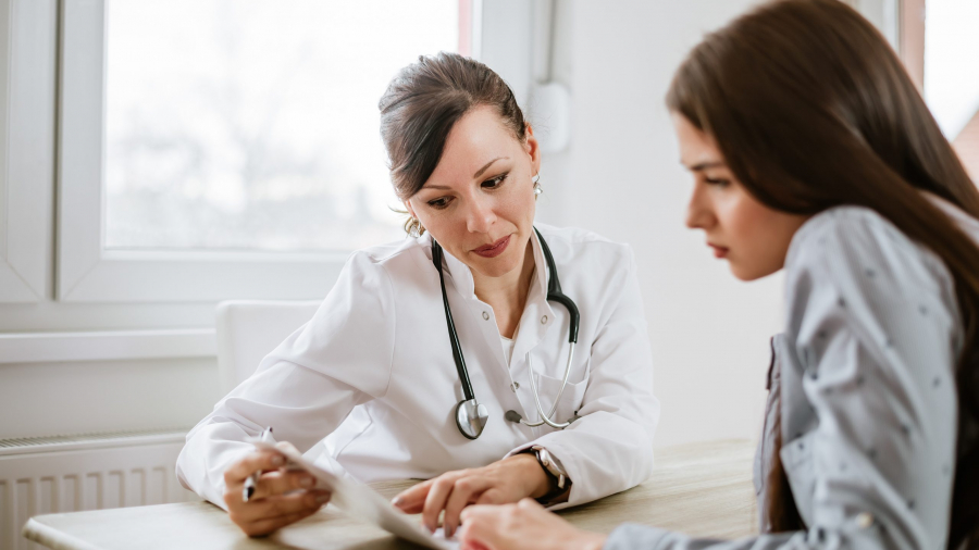 Charming female doctor giving advice to a female patient.